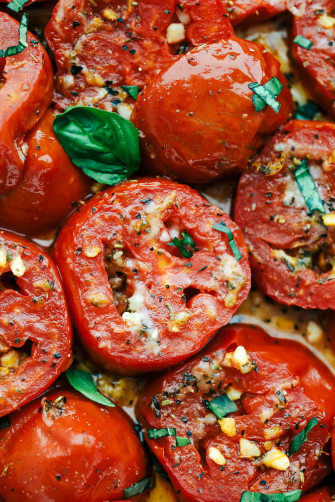 A sensational seasonal must have side dish, this is bursting with juicy savory flavor. These roasted and seared to perfection tomatoes are a perfect quick go to. Topped with cheesy goodness and fresh basil this is sure to please any crowd. Sliced tomatoes roasted with garlic and basil.