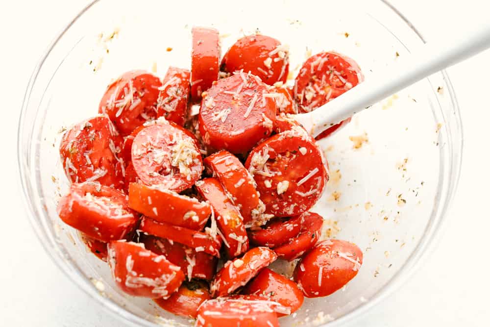 A sensational seasonal must have side dish, this is bursting with juicy savory flavor. These roasted and seared to perfection tomatoes are a perfect quick go to. Topped with cheesy goodness and fresh basil this is sure to please any crowd. Roasted tomatoes with spices and seasonings.