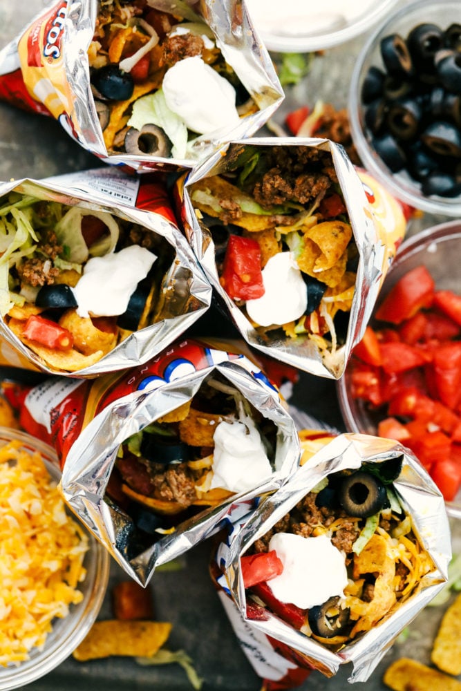 Walking Tacos are quick and easy deconstructed tacos that are made and served right in a chip bag. Great for active parties or on the go meals because they are filling and fast! Overhead view of walking tacos.