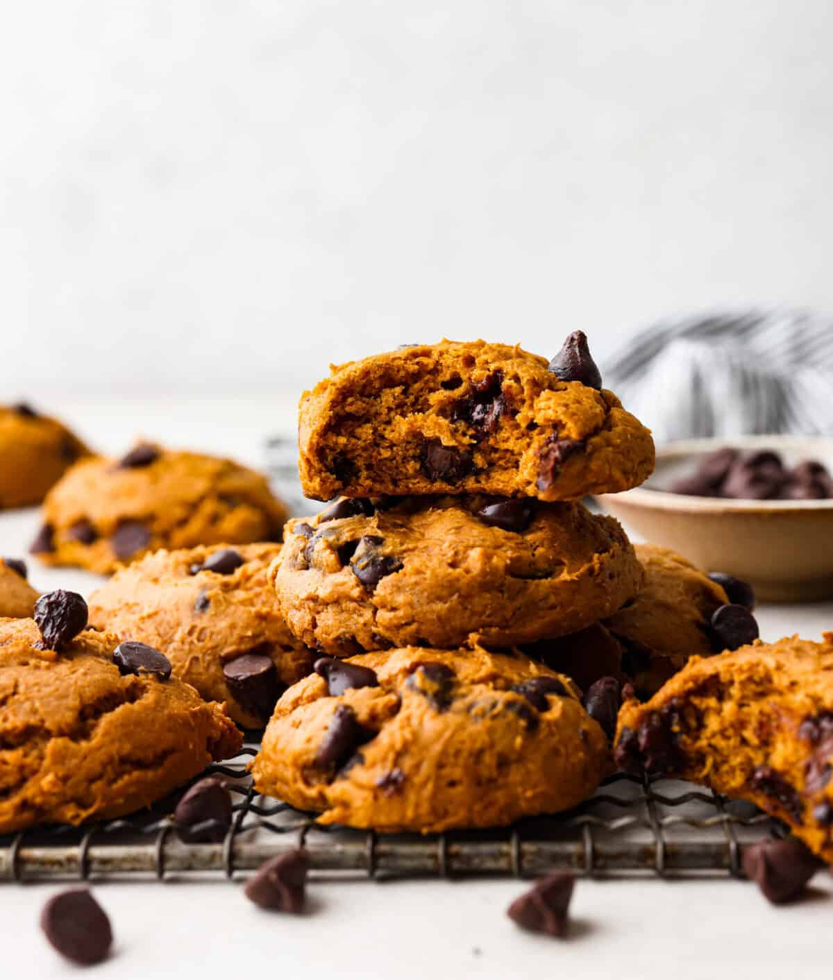 Easy as 1,2,3, these delicious pumpkin chocolate chip cookies are super quick and tasty! They are light, fluffy, and packed with pumpkin flavor and silky milk chocolate. With only three ingredients, it can’t get much easier than that! Side shot of a stack of 3 ingredient pumpkin chocolate chip cookies.