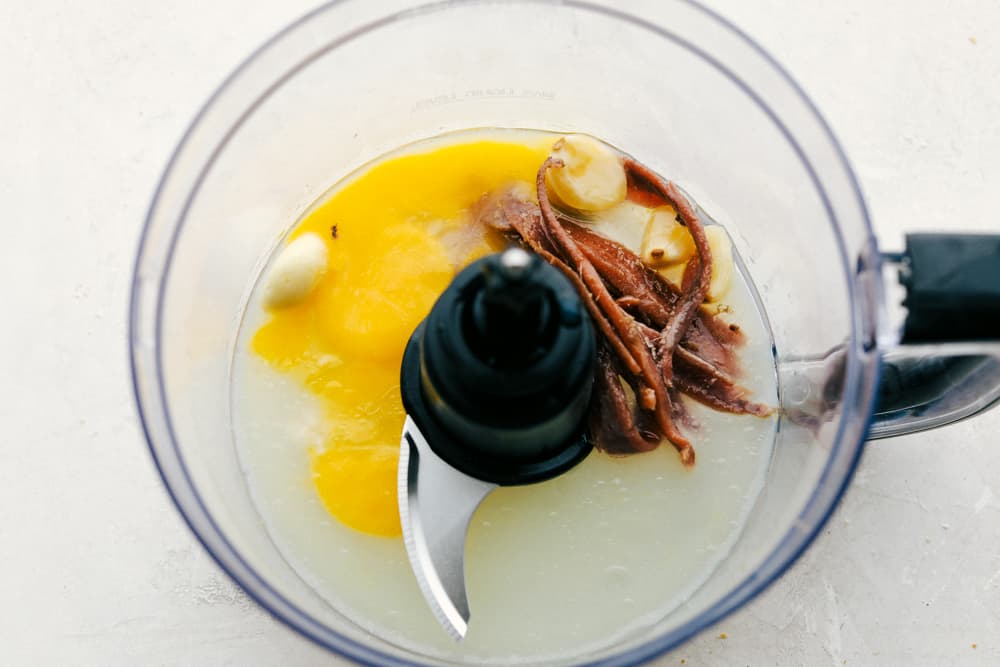Authentic Caesar Dressing is rich creamy and so much better homemade than from a jar. You are going to love how simple this really is and the savory flavor is going to WOW you! It will Change the way you eat anything Caesar forever! Making Rich and Creamy Authentic Caesar Dressing.