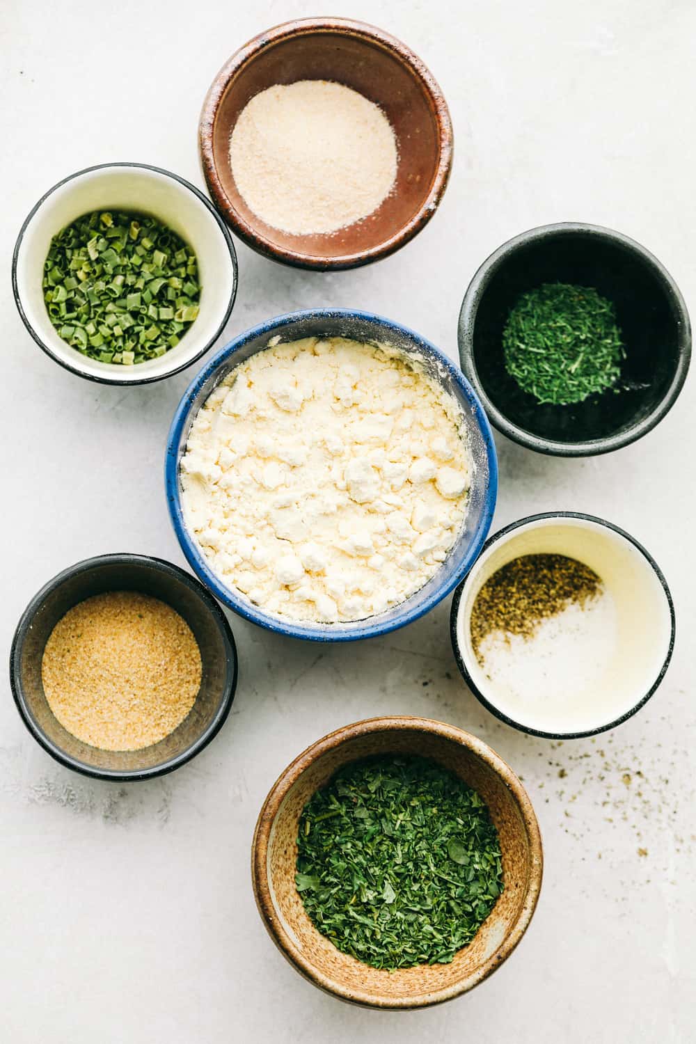 Perfectly seasoned, Homemade Ranch Seasoning Mix is easy, quick and oh so good! Making Homemade Ranch Seasoning with the seasonings in different bowls.