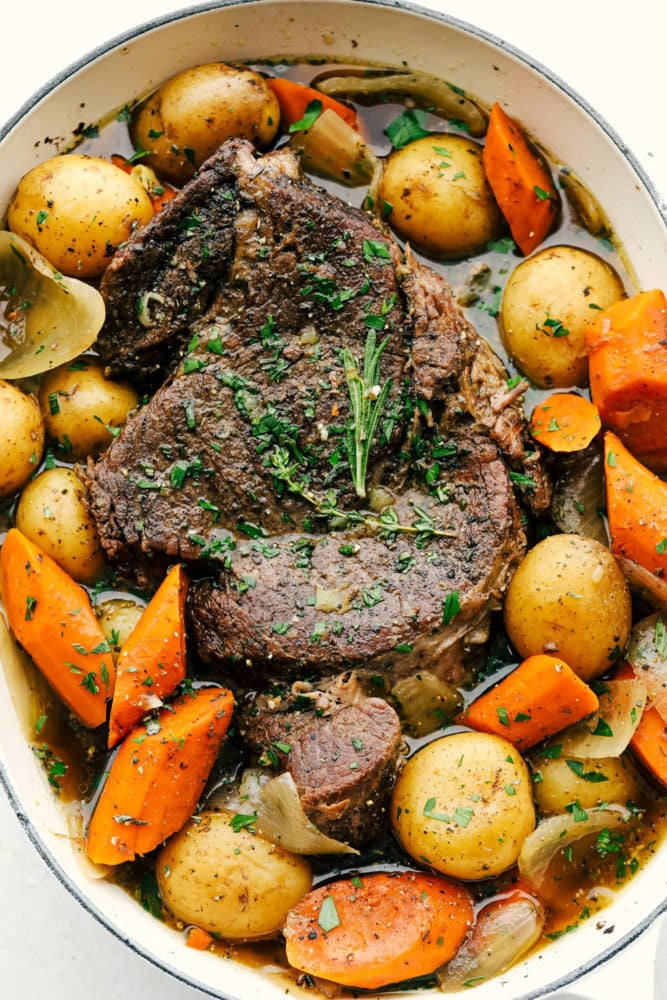 Fork-tender, melt-in-your-mouth pot roast with delicate potatoes and sweet carrots in a perfectly seasoned broth. This recipe is super simple but will make you feel like you've spent all day cooking. Melt in you mouth pot roast with tender carrots and potatoes