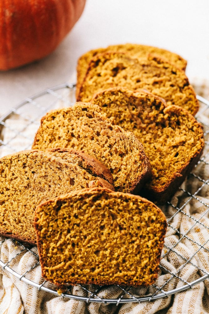 This Absolutely Perfect Pumpkin Bread is moist, spiced and will fill your home with the most amazing aroma. Your friends and family will devour this flavorful bread that screams it's time for fall. This is such an easy quick bread, you'll make it all the time. Perfectly spiced moist and tender pumpkin bread sliced up.