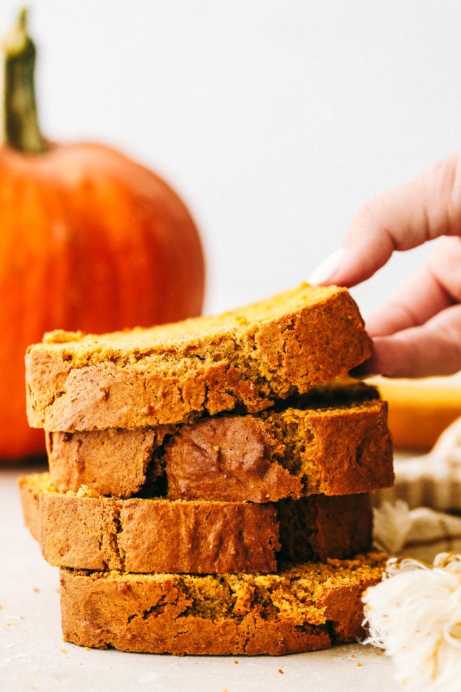 This Absolutely Perfect Pumpkin Bread is moist, spiced and will fill your home with the most amazing aroma. Your friends and family will devour this flavorful bread that screams it's time for fall. This is such an easy quick bread, you'll make it all the time. Perfectly spiced moist and tender pumpkin bread stacked on top of each other.