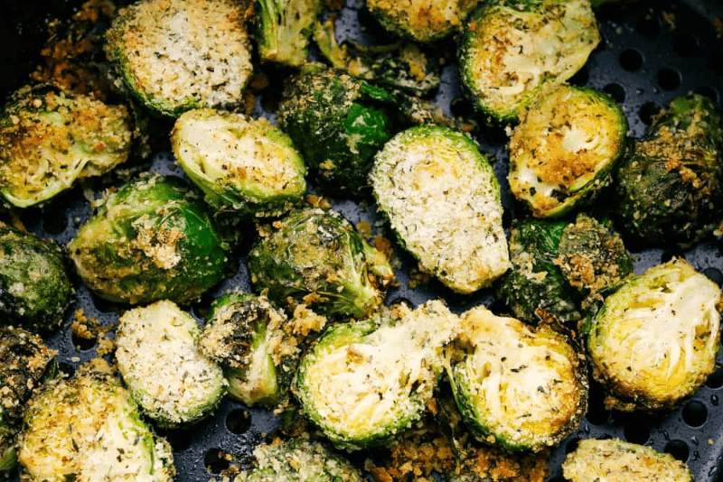 The air fryer is one of the most versatile appliances in today's kitchen! Learn how to use an air fryer to cook, reheat, and achieve that "fried" texture without frying in oil. Once you cook in the air fryer you will never look back! First photo of Brussels sprouts cooked in the air fryer.