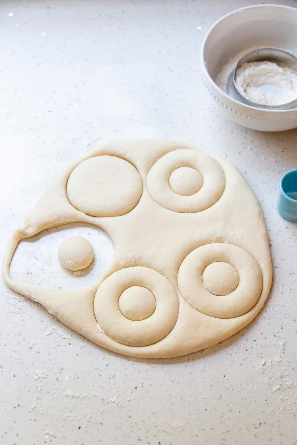 Homemade Donuts are easier to make than you might think! And yes, I’m talking about soft and fluffy fried yeasted donuts, dressed in your choice of vanilla or chocolate glaze. Cutting out the dough for donuts