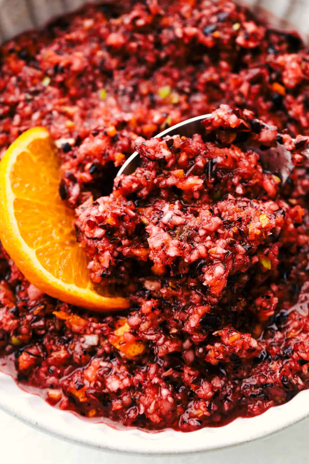 This is the easiest, most zingy, colorful and flavorful Cranberry Relish. Make your next Turkey sing with this fresh relish. It's super easy, full of fresh flavors and tops just about anything. Sweet, zingy, colorful Cranberry Relish.