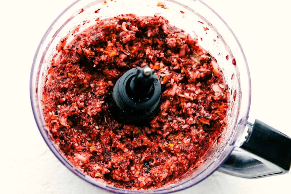 This is the easiest, most zingy, colorful and flavorful Cranberry Relish. Make your next Turkey sing with this fresh relish. It's super easy, full of fresh flavors and tops just about anything. Blended Cranberry Relish.