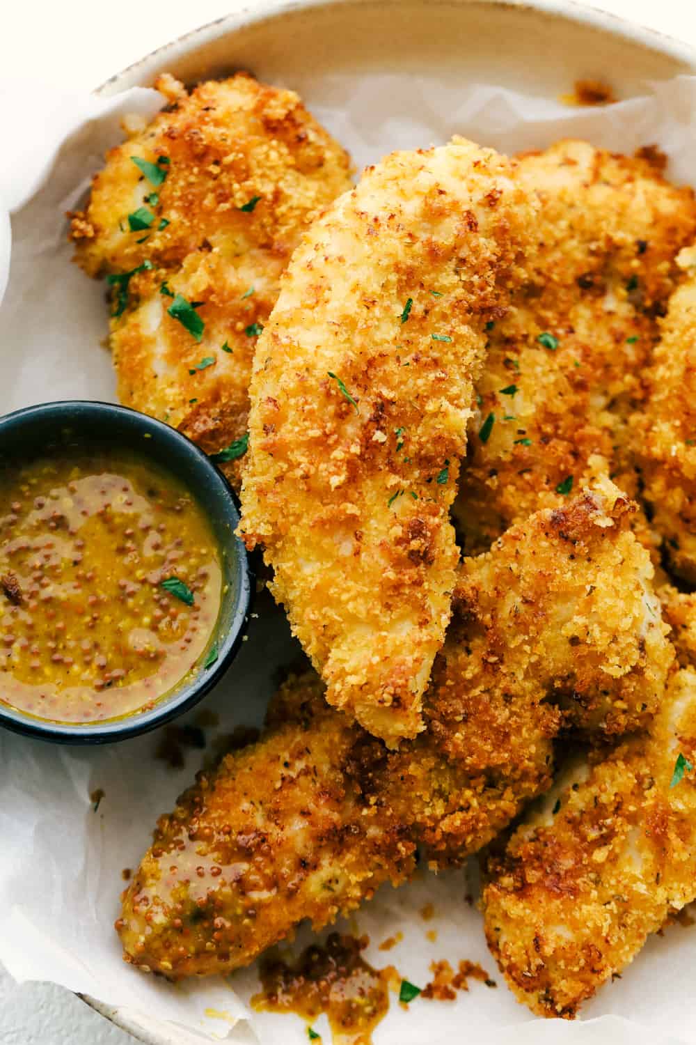 Crispy Parmesan Air Fryer Chicken Tenders are crispy golden outside and tender juicy inside with hint of garlic and tons of flavor. They are perfect for a quick dinner, lunch or even snack. Crispy golden outside, juicy tender inside, Air Fryer Chicken Tenders.