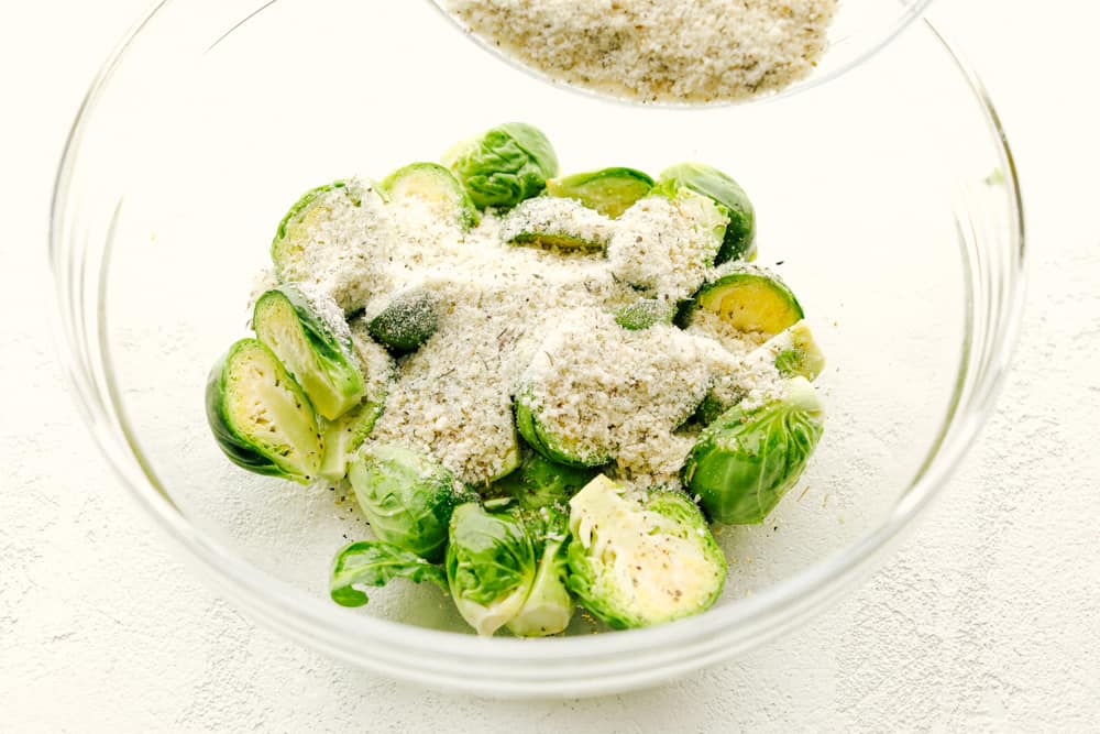 Crispy Parmesan Air Fryer Brussels Sprouts are super easy, packed with flavor and have tasty golden crunch. This is going to be one of the best ways to get your kids to say "More Please!" when it comes to their veggies. These are just that good! Coating the brussel sprouts with parmesan and seasonings.