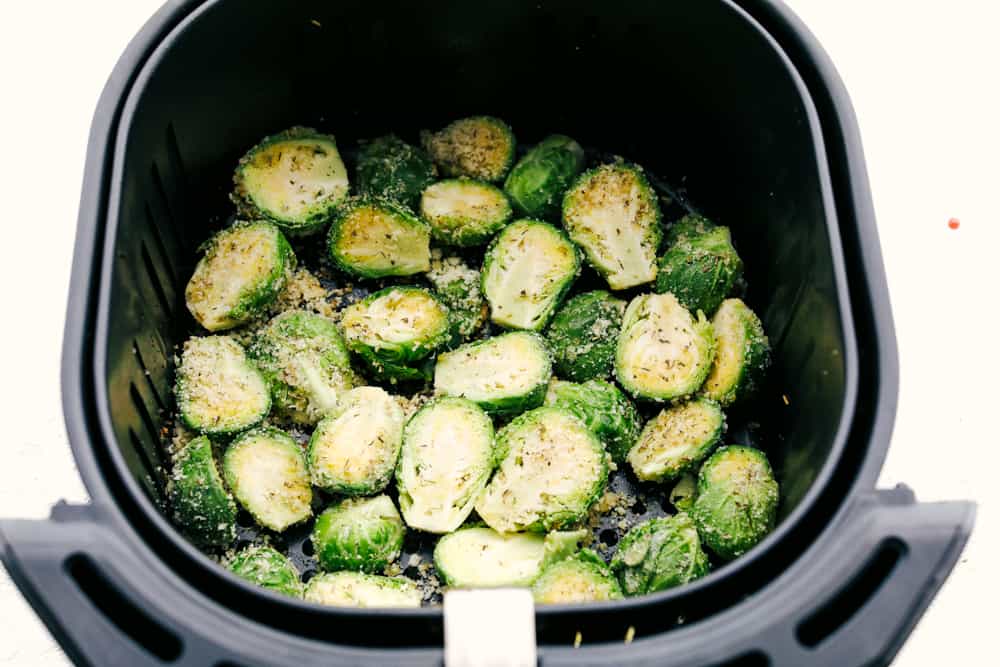 Crispy Parmesan Air Fryer Brussels Sprouts are super easy, packed with flavor and have tasty golden crunch. This is going to be one of the best ways to get your kids to say "More Please!" when it comes to their veggies. These are just that good! Parmesan coated Brussel Sprouts in the air fryer.