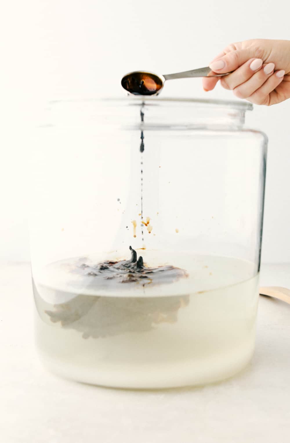 This Homemade Root Beer is a fun, sweet, refreshing treat to make any occasion extra special. It takes just 4 ingredients to create a little magic and a whole lot of tasty fun! ย Adding in Root Beer extract to the sugar mixture.