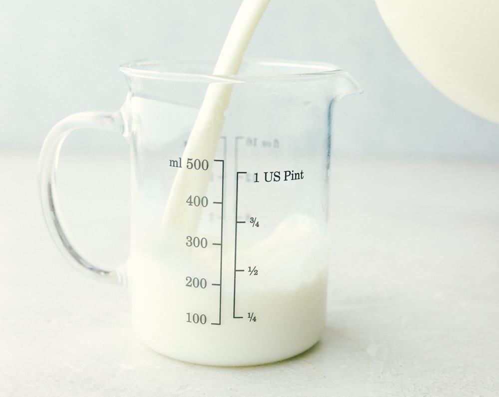 This guide gives you easy swaps that actually work. Save this list and come back to it anytime you need a quick answer! Milk being poured into a measuring container.