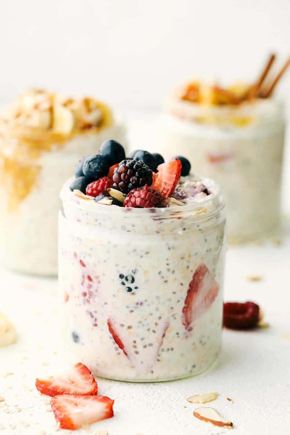 Overnight Oats are a healthy, versatile, make ahead, portable filling breakfast to get you on your way. These oats have to be one of the best inventions EVER! Over night oats in a jar with mixed berries on top.