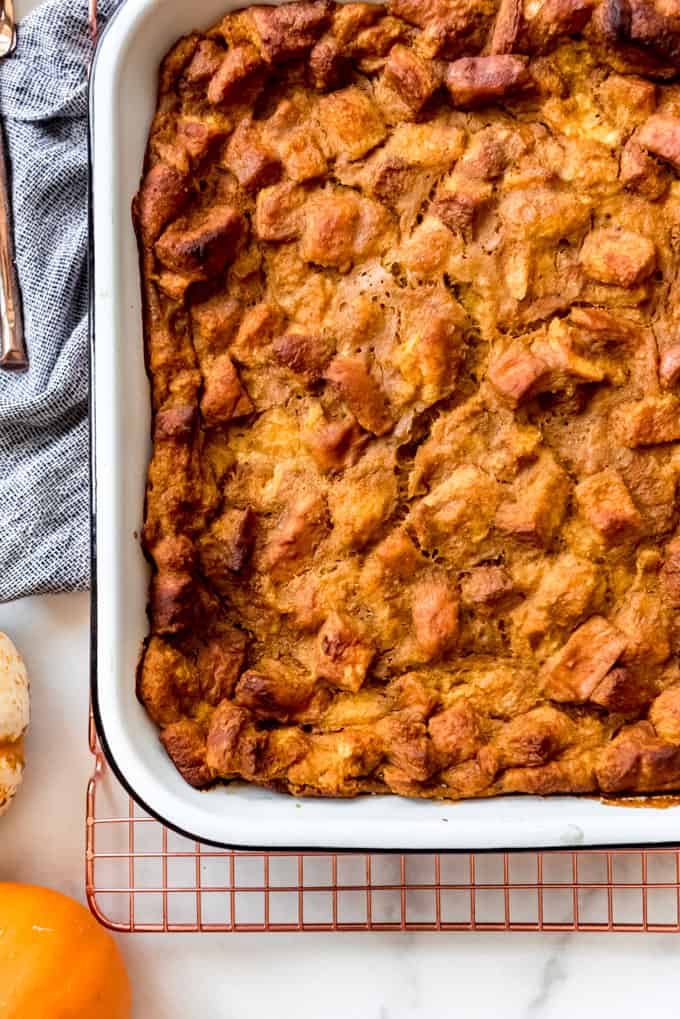 Pumpkin Bread Pudding is an easy and fantastic recipe that tastes like you have spent a lot of time putting it together when it really only takes minutes! Drizzle warm slices with caramel sauce and serve it with ice cream for a decadent dessert, or even enjoy it for breakfast like a baked french toast casserole! A pan of pumpkin bread pudding.