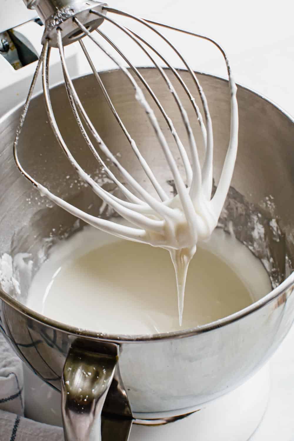 This classic and simple royal icing recipe is a cookie decorating staple with a smooth consistency that sets quickly without hardening too much. Made with meringue powder it has a delicious taste and a smooth texture that's perfect for flooding and piping cookies. Royal icing in an electric mixing bowl.
