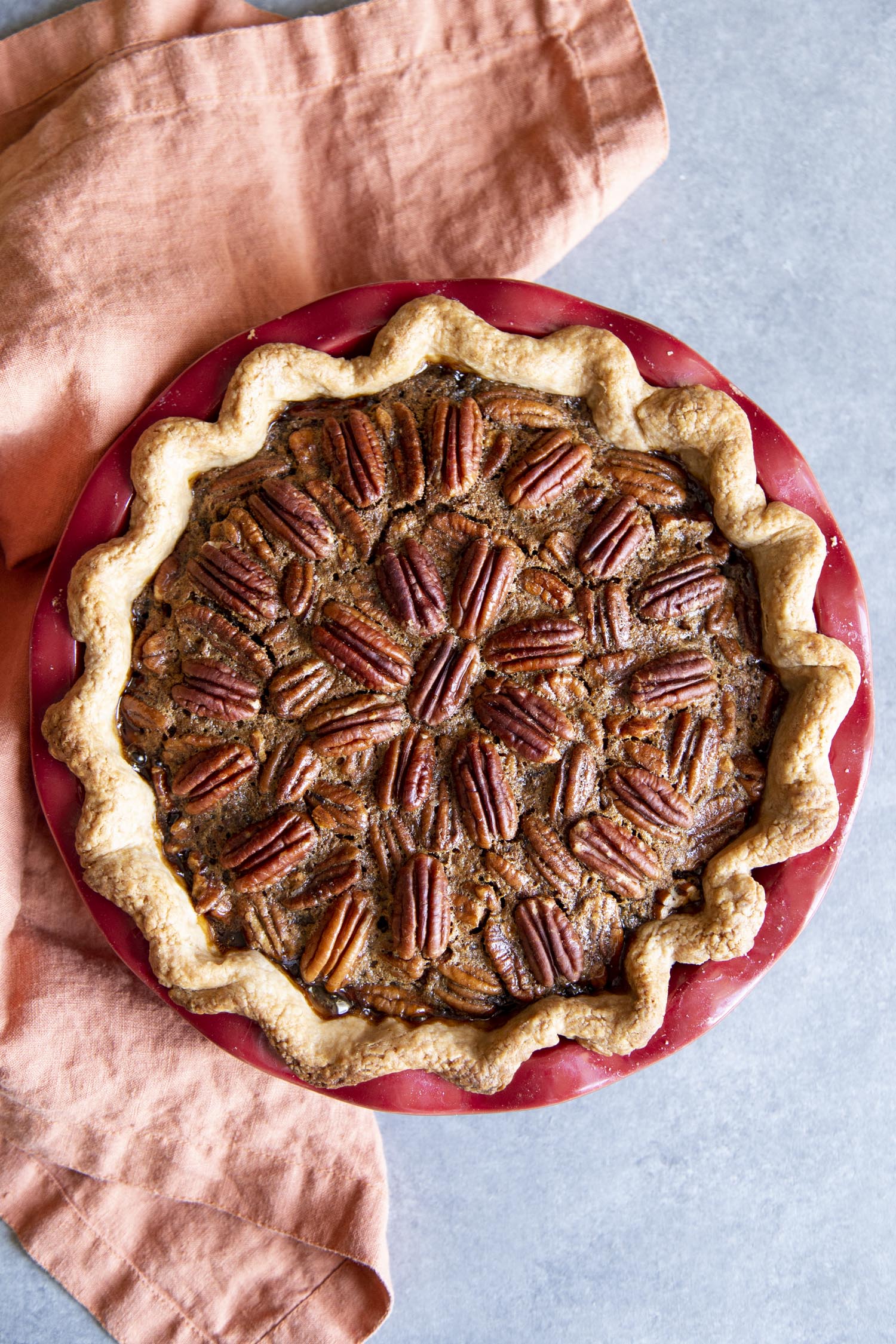 Amazing Decadent Pecan Pie is a rich, chewy, nutty, sweet, traditional holiday staple. For many the holidays aren't the holidays without this brilliant dessert on the table. This homemade delight is surprisingly super simple. You are going to love it! Rich, decadent Pecan pie.