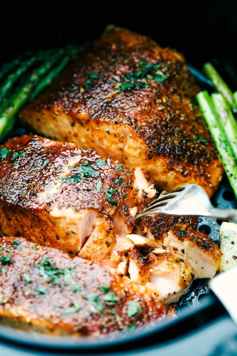 Melt-in-your-mouth brown sugar garlic air fryer salmon is juicy, tender and full of flavor.ย Salmon is so good, especially when it's cooked right, and the air fryer makes it perfect every time! It's an easy, hands-off way to make a scrumptious meal. Closeup of tender, juicy Brown Sugar Garlic Salmon