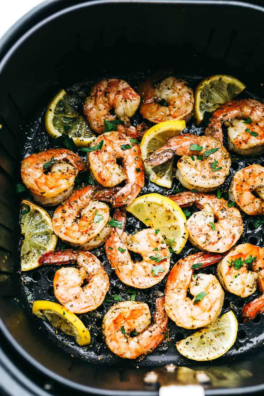 This air fryer shrimp is tender, delicious, and so easy to make! With only a few ingredients, the marinated shrimp cooks to perfection and has the best flavor! Shrimp with lemons in air fryer.