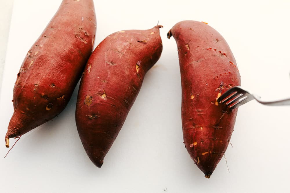 Perfectly fluffy and tender on the inside, crispy on the outside, these Air Fryer Sweet Potatoes are going to rock your world! They are so creamy inside it's amazing. Just add your favorite topping and you'll have a new favorite way to eat these delicious sweet potatoes. Sweet Potatoes getting prepared for the Air Fryer.