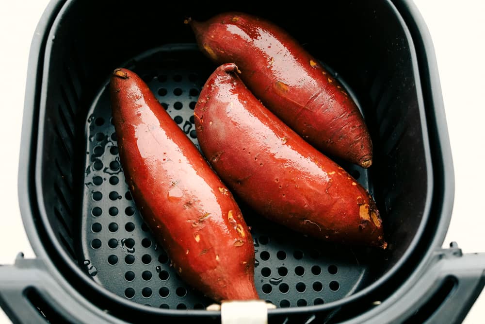 Perfectly fluffy and tender on the inside, crispy on the outside, these Air Fryer Sweet Potatoes are going to rock your world! They are so creamy inside it's amazing. Just add your favorite topping and you'll have a new favorite way to eat these delicious sweet potatoes. Prepared Sweet Potatoes ready for the Air Fryer.