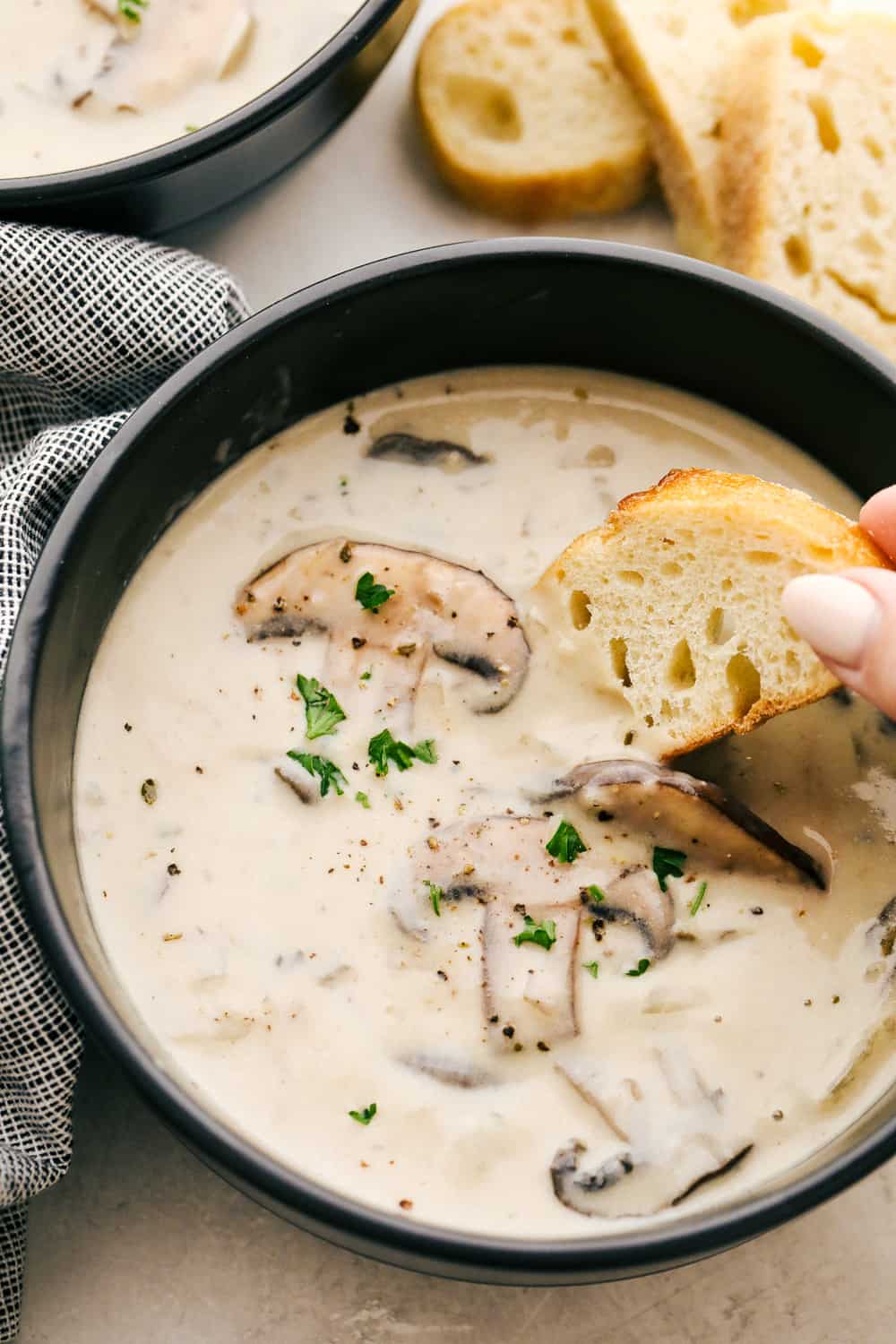 Cream of Mushroom Soup is a dreamy creamy soup full of delicately flavored sauteed mushrooms and herbs. If you love the taste of cream of mushroom soup, but can stand the canned version, this is for you! This is a fancy, thick, rich, restaurant worthy soup you can whip up at home in no time.ย Creamy dreamy homemade Cream of Mushroom Soup
