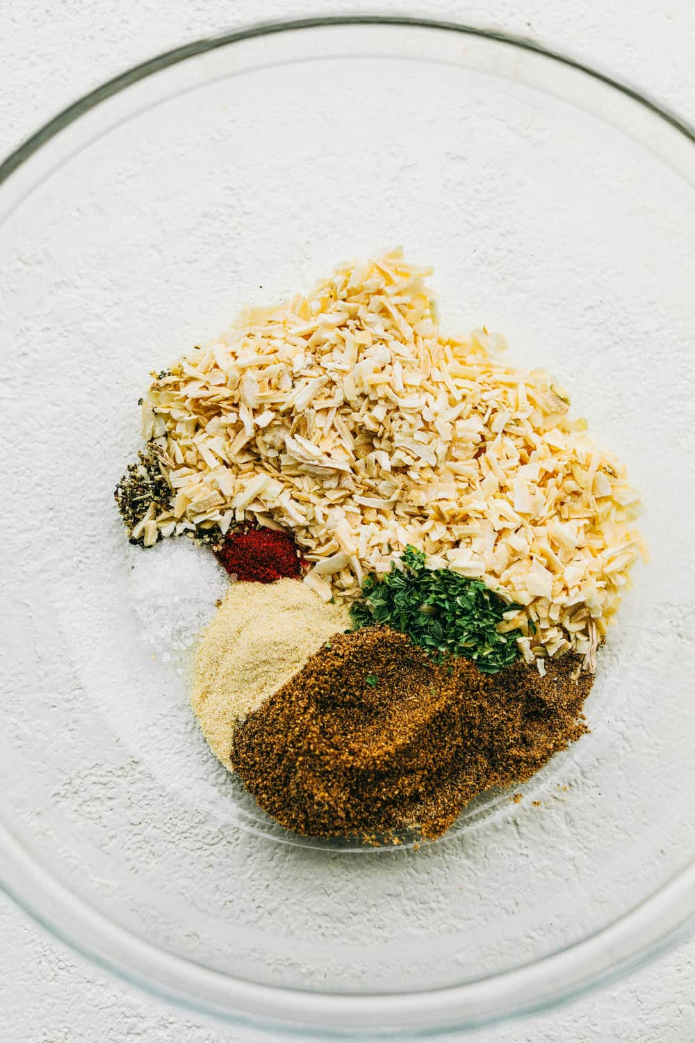 Homemade Onion Soup Mix is super easy, perfectly seasoned and tastes better than store bought mix. Making your own mix puts the mind at ease, you know exactly what's in it, it's cheaper and tastes amazing. It's so simple you can whip it up whenever you need it. Bowl of spices for homemade onion soup mix.