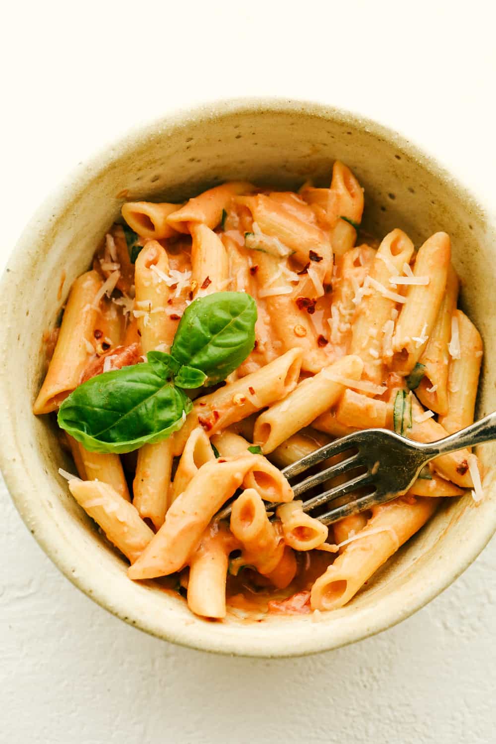 Penne alla Vodka is creamy, full of flavor and absolutely divine! This simple yet elegant dish is exploding with a creamy rich tomato sauce, and tender pasta. Perfect dinner anytime of the week! Creamy flavorful Penne Alla Vodka in a bowl.
