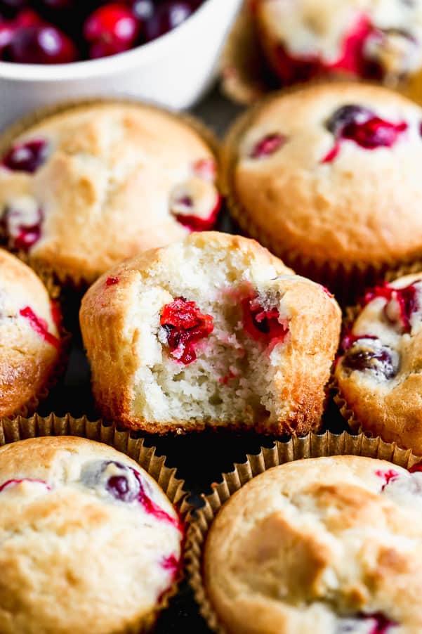 These Cranberry Muffins are the perfect blend of tart and sweet, light, fluffy and perfect for your morning breakfast. All you need is one bowl and 30 minutes to whip these babies up from start to finish. Cranberry muffins stacked together.