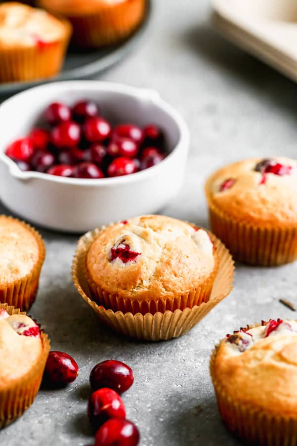 These Cranberry Muffins are the perfect blend of tart and sweet, light, fluffy and perfect for your morning breakfast. All you need is one bowl and 30 minutes to whip these babies up from start to finish. Cranberry muffins with cranberries in a bowl.