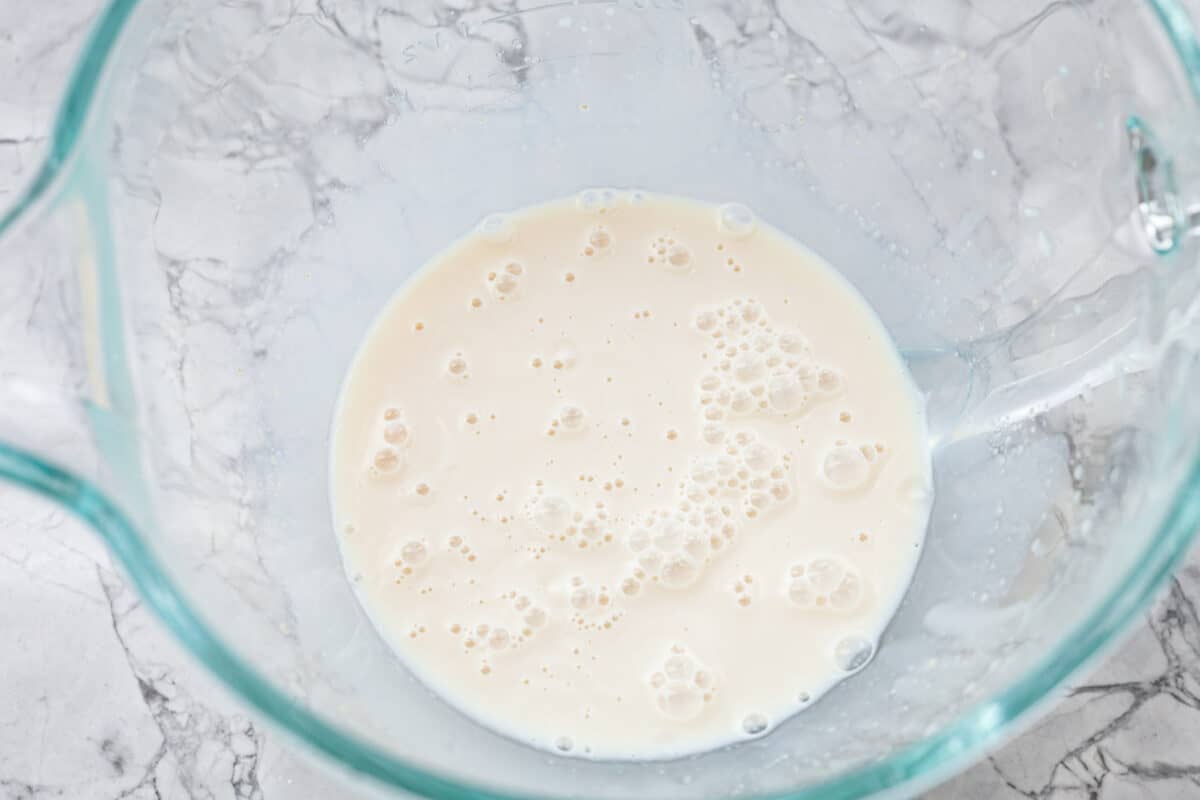 Lion House Rolls are the best dinner rolls for holiday meals or any occasion. These buttery, super-soft rolls are the perfect vehicle for soaking up delicious soups, sauces, and gravies. Overhead shot of milk and yeast in a mixing bowl.