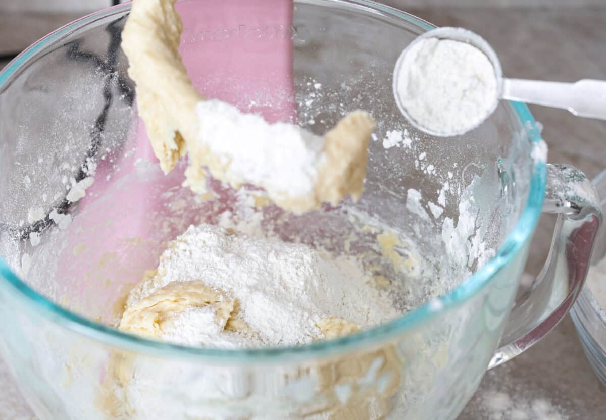 Lion House Rolls are the best dinner rolls for holiday meals or any occasion. These buttery, super-soft rolls are the perfect vehicle for soaking up delicious soups, sauces, and gravies. Angle shot of ingredients added to a mixing bowl, and someone added flour one tablespoon at a time.