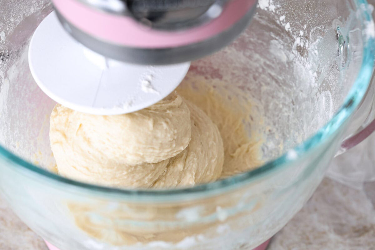 Lion House Rolls are the best dinner rolls for holiday meals or any occasion. These buttery, super-soft rolls are the perfect vehicle for soaking up delicious soups, sauces, and gravies. Angle shot of dough being mixed in a stand mixer.