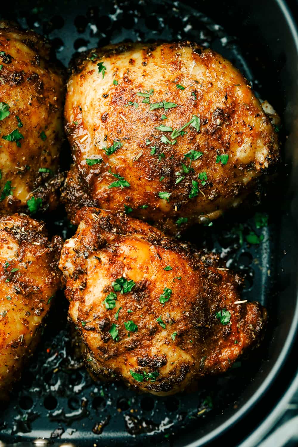Crispy and Juicy Air Fryer Chicken Thighs are the perfect thing to make tonight! Perfectly seasoned, these are the most scrumptious chicken thighs EVER! Tender, juicy Air Fryer Chicken Thighs.