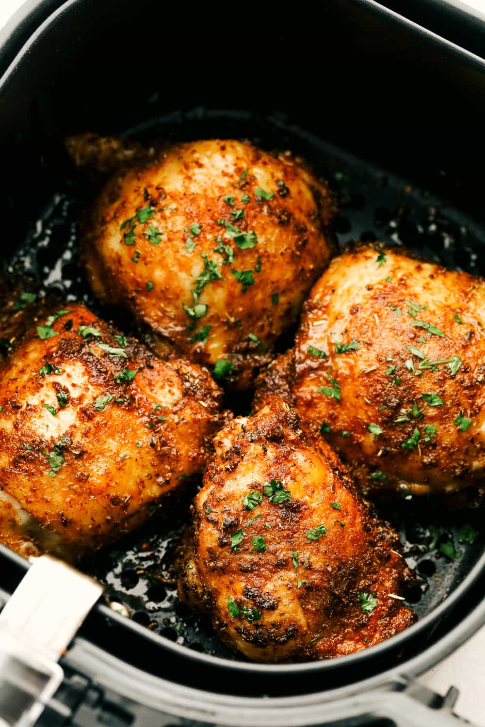 Crispy and Juicy Air Fryer Chicken Thighs are the perfect thing to make tonight! Perfectly seasoned, these are the most scrumptious chicken thighs EVER! Air fryer chicken thighs perfectly seasoned.