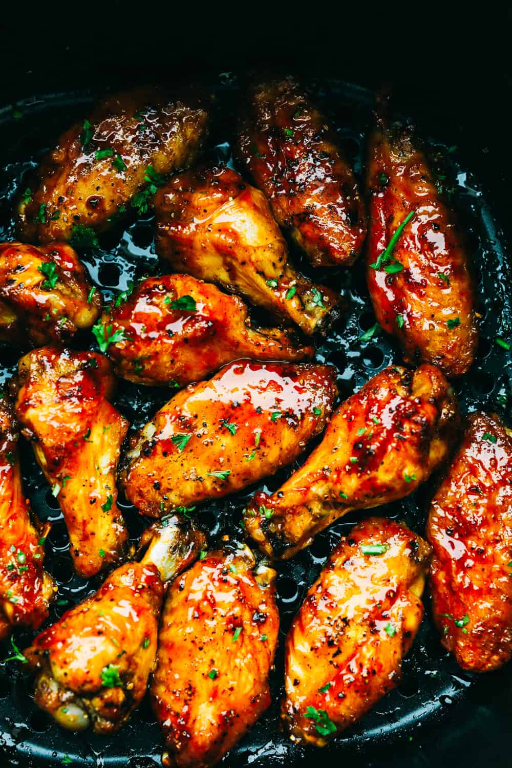 Crispy Air Fryer Chicken Wings are simply the best ever! Crispy on the outside, tender on the inside and with a smack of homemade buffalo sauce, they're finger lick'n good! Spicy and crispy air fryer chicken wings with sauce.