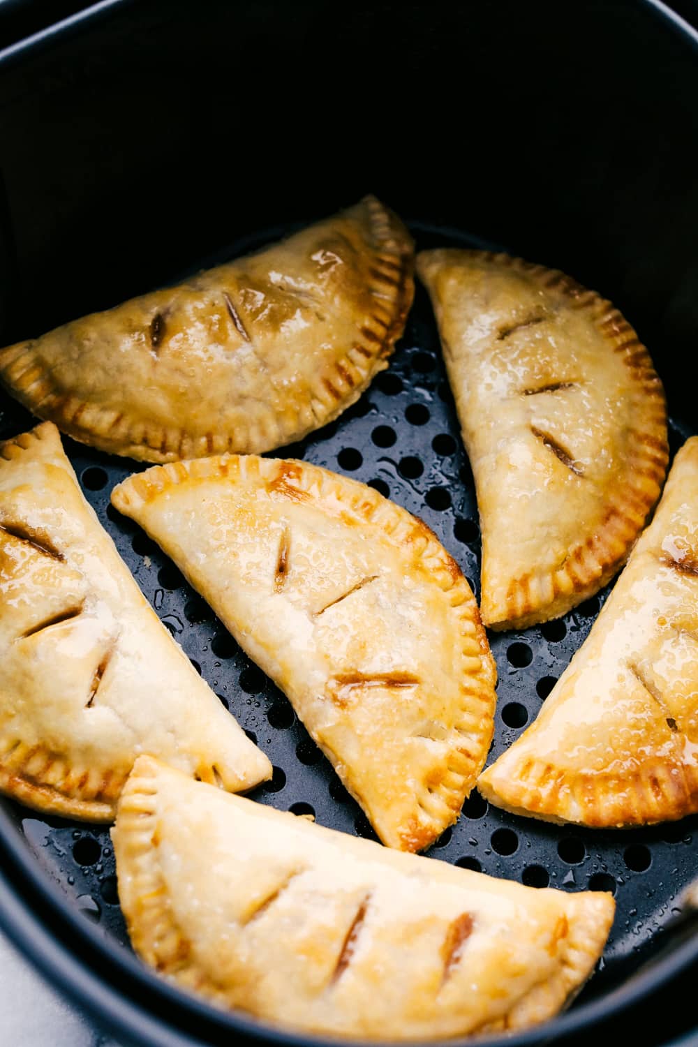 Seriously Amazing Air Fryer Hand Pies are an easy way to have dessert! Tender sweet spiced apples in a flakey crust you can hold in your hand! Hand held apple pies made in the air fryer.