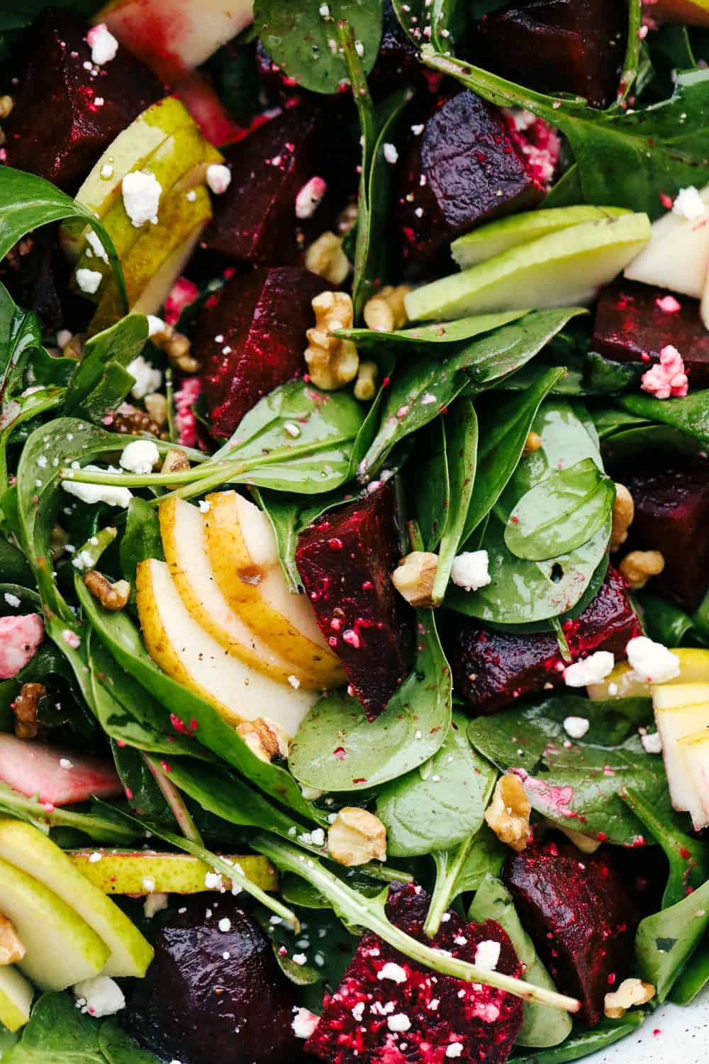 This Amazing Pear and Beet Salad is fresh, zingy, and absolutely delicious. It's a perfect combination of crisp-tender pears, sweet roasted beets, mixed greens all tossed in a honey vinaigrette. Pears, beets, feta, spinach and walnuts tossed together in a vinaigrette.