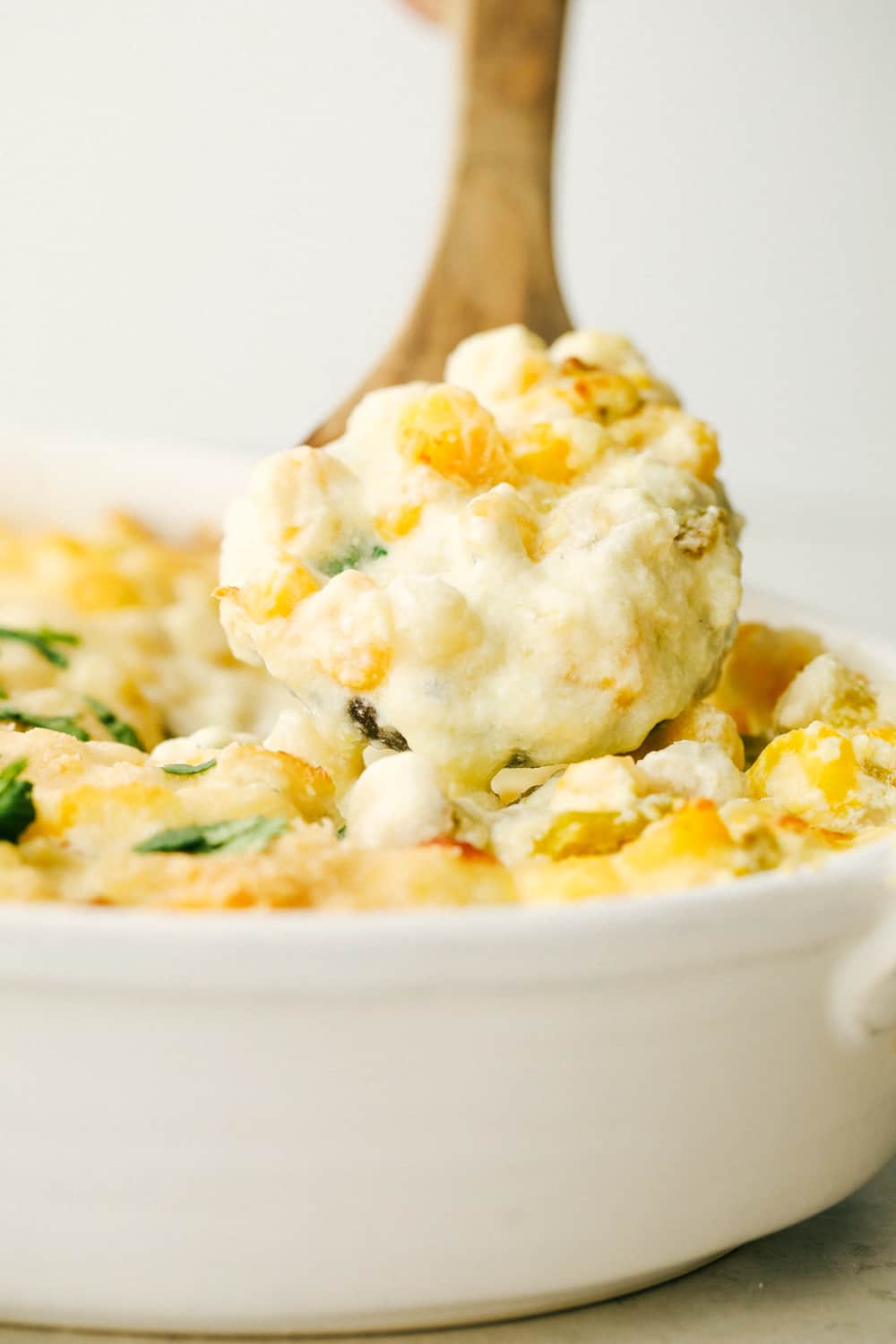 Easy, creamy and cheesy Hominy Casserole is a side dish that is sure to impress. This is not your average dish, it takes hominy to a whole new level. Scooping out creamy cheesy hominy casserole.