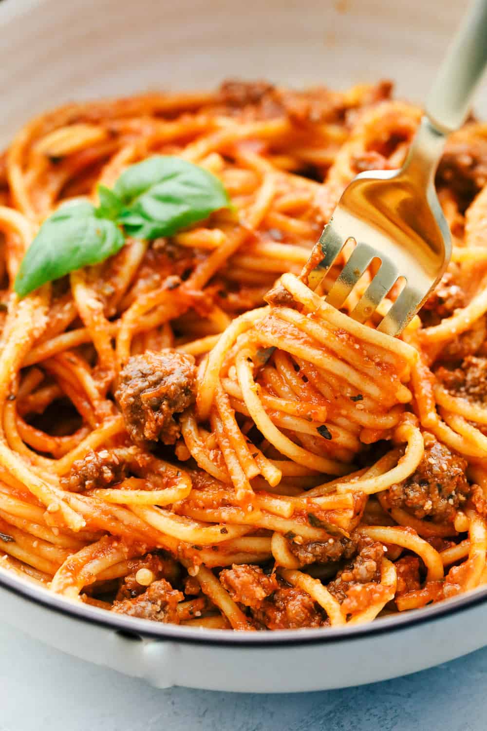 For those nights when you need something fast and easy turn to 10 minute Instant Pot Spaghetti. Superbly seasoned beef and tender noodles all cook together in a delectable sauce and is ready in no time. A fork with instant pot spaghetti wrapped around it.