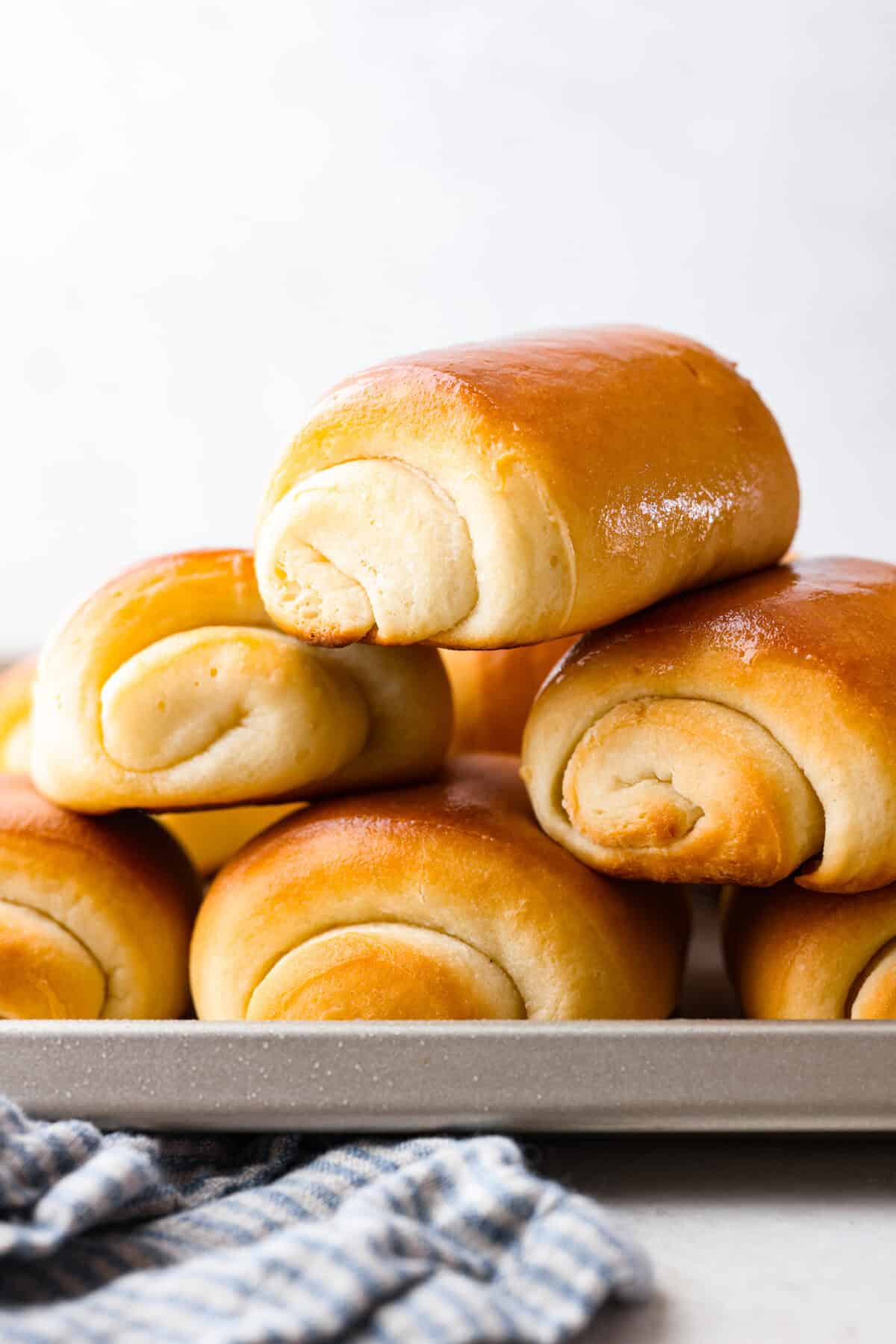 Lion House Rolls are the best dinner rolls for holiday meals or any occasion. These buttery, super-soft rolls are the perfect vehicle for soaking up delicious soups, sauces, and gravies. Side shot of a stack of lion house rolls.
