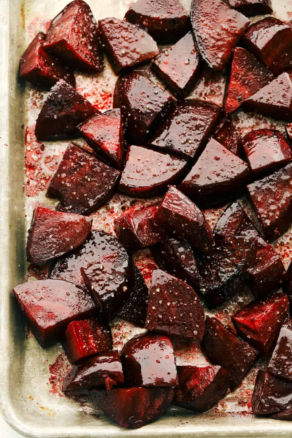 Perfect Roasted Beets are tender, flavorful and vibrant in color. These beets are the perfect companion to most any dish and are delish add ins to salads! Try these today! Roasted beets on a cookie sheet.