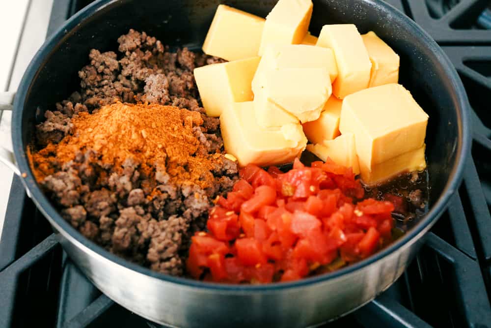 Amazing Rotel Dip is the easiest and most delectable dip for any occasion! Perfectly spiced hamburger, creamy cheese and full flavored Rotel tomatoes combine in this quick appetizer, everyone will love. Mixing hamburger, cheese, spices and tomatoes for an amazing dip.