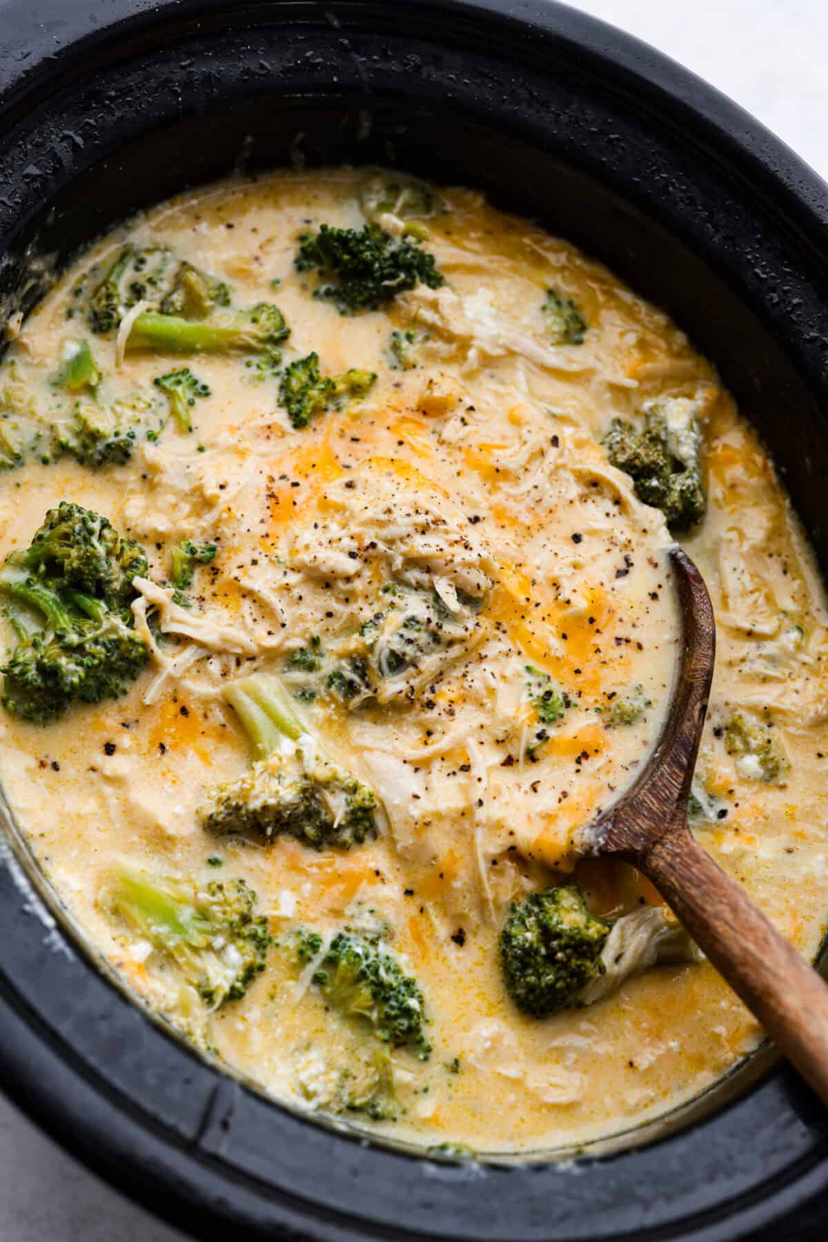Slow-cooker creamy chicken and broccoli over rice is a super easy, delicious meal the whole family will love! Moist chicken and tender broccoli combine in a cheesy sauce that's absolutely divine.ย Overhead shot of slow cooker creamy chicken and broccoli in a crockpot.