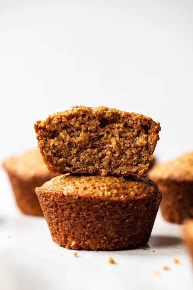 These bran muffins are incredibly tender and flavorful. Look no further for a tasty, and healthier start to your day!ย Bran muffins stacked on top of each other.