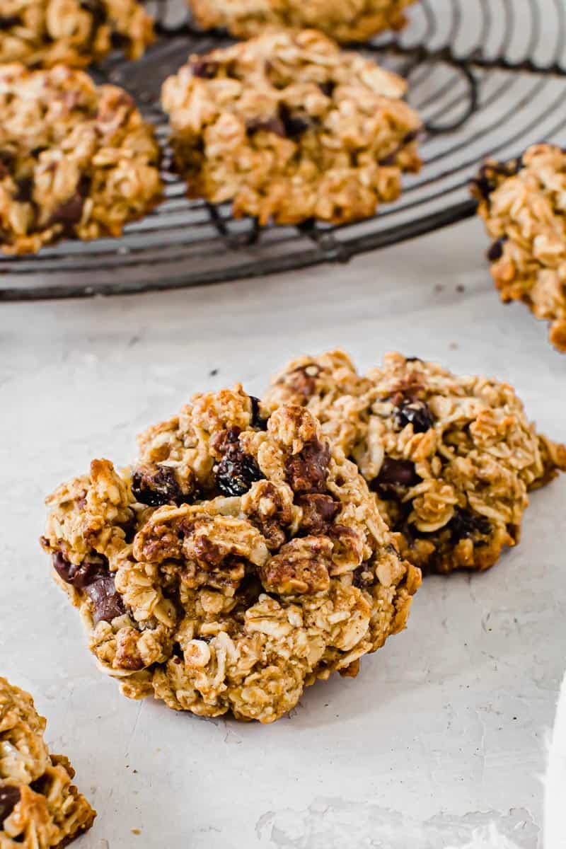 Sweet and slightly chewy, these Healthy Oatmeal Cookies taste just as good as the classic. With better ingredients such as coconut oil and maple syrup instead of sugar, these cookies have a healthier nutrition label than others.ย Healthy oatmeal cookies on top of each other.