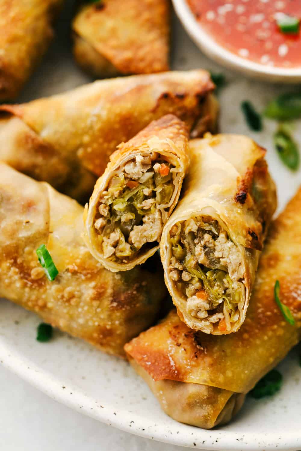 Egg Roll lovers, this Crispy Air Fryer Egg Roll Recipe is for you! Crispy, crunchy outside, tender filling inside, without the extra fat of frying or drying out from oven cooking. These are what you have been waiting for! Perfectly cooked and filled cross section of an egg roll.
