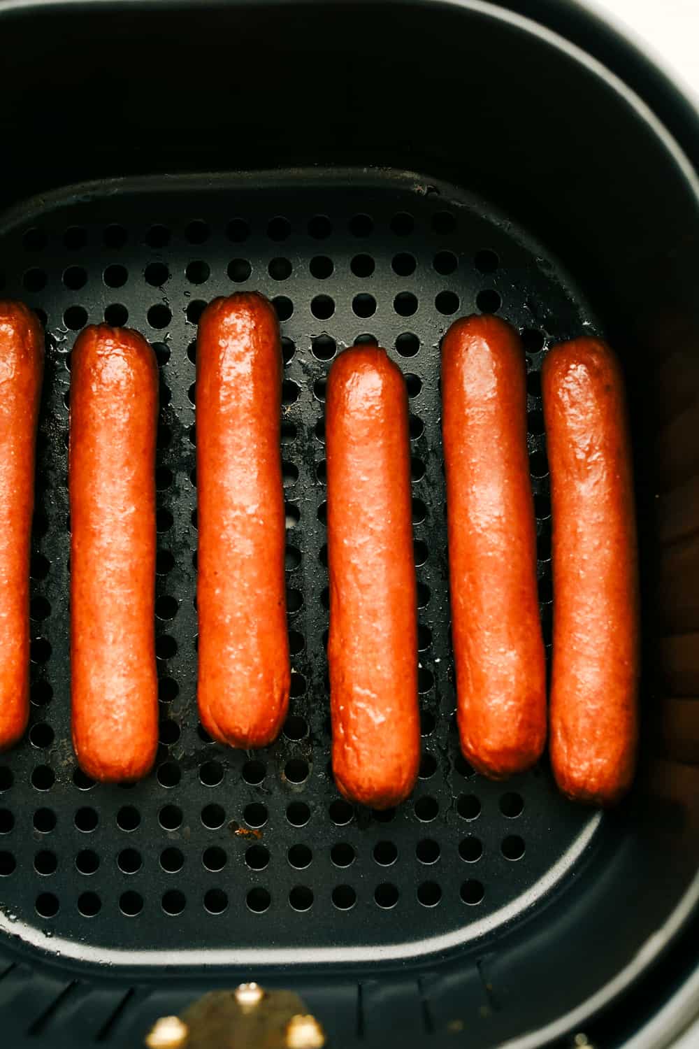 Air Fryer Hot Dogs taste better than any grilled, boiled or game-day hot dog you have ever had! Making them in the Air Fryer is a game changer! Up close picture of cooked hot dogs.