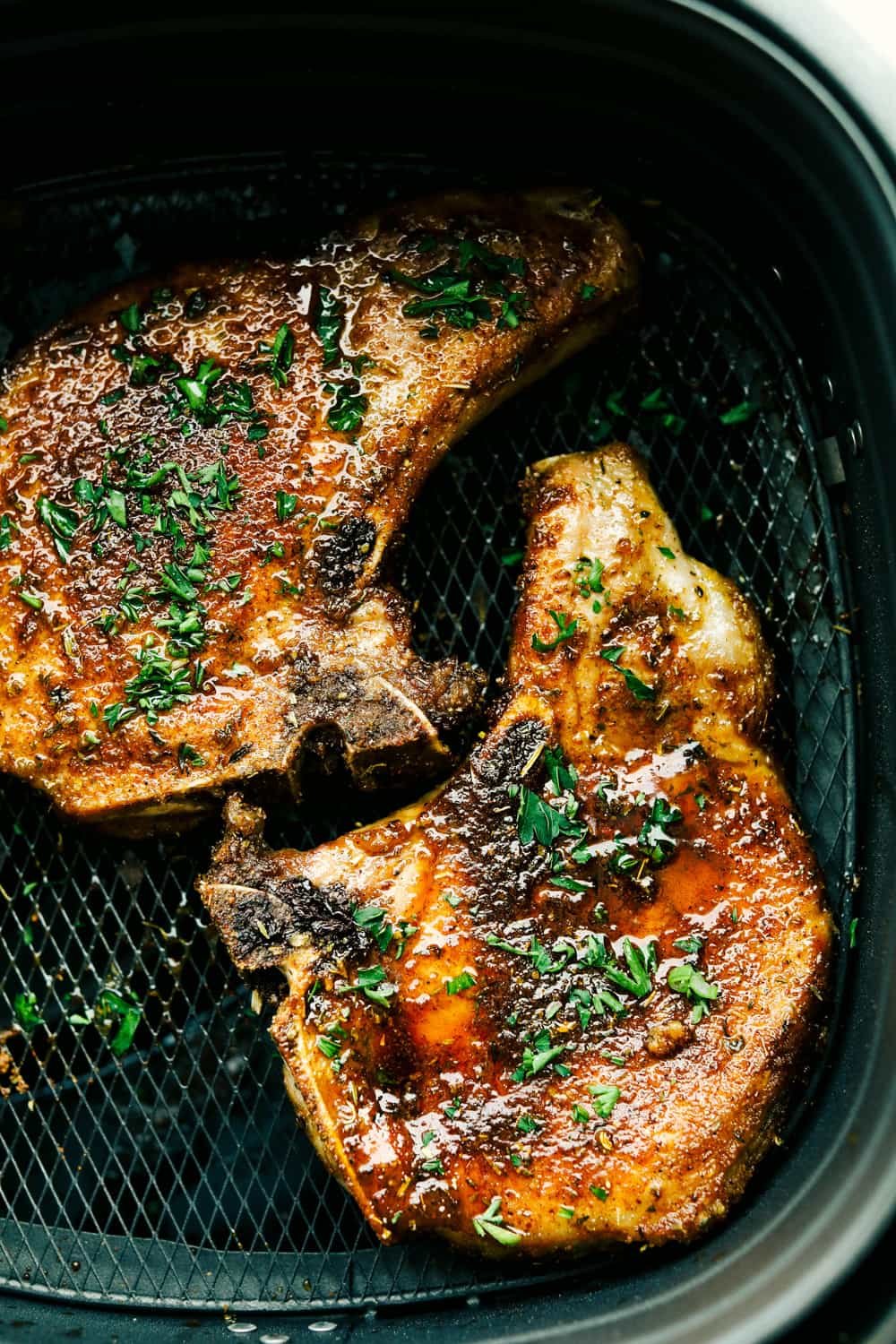 Air Fryer Pork Chops are the best pork chops ever! With a golden seasoned crust and fork tender juicy insides, it is makes these the perfect pork chops.ย Juicy and flavorful Air Fryer Pork Chops.